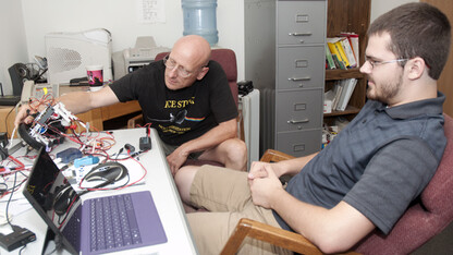 SCINI team members Bob Zook (left) and Alex Wilke work with an electronic component of the new Deep-SCINI remote operated vehicle. The team plans to deploy the new underwater robot in October.