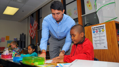 UNL's Emanuel "Manny" Maldonado assists an Everett Elementary student with a math lesson on Sept. 10. Maldonado has worked at Everett for three years as a participant in America Reads, America Counts, a federal work-study program.