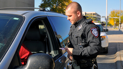 Officer Eric Fischer talks with a driver during a routine traffic stop. The UNL Police Department has received accreditation after a three-year review by the Commission  on Accreditation for Law Enforcement Agencies.