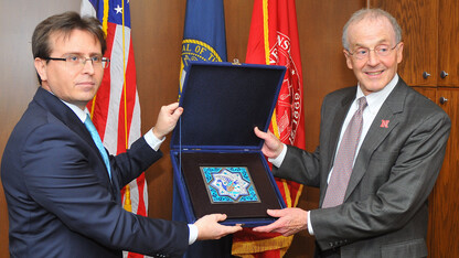 Ramis Sen, the Turkish consular general based in Chicago (left), presents a gift to Chancellor Harvey Perlman during a Dec. 16 visit.
