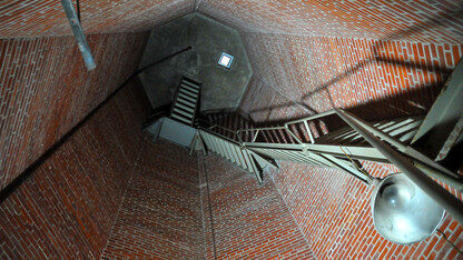 To get to the top of UNL's Mueller Tower, maintenance workers ascend a steel staircase that spirals up the inside of the bell tower.