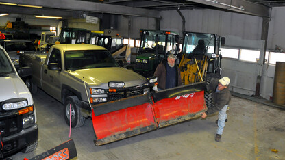 Landscape Services employees (from right) Kirby Baird and Dale Schmidt check snow blade as part of prep work for a forecasted snow storm. The Feb. 4 storm is projected to drop between two and 10 inches of snow in Lincoln.