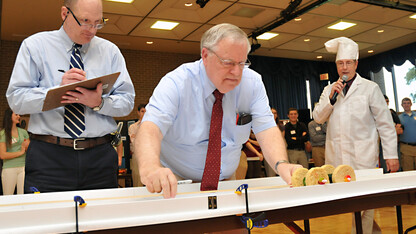 Race officials measure the distance covered by an entry in the 2012 Incredible, Edible Vehicle Competition. The annual engineering event is 2 to 4 p.m. Dec. 10 in the East Union.