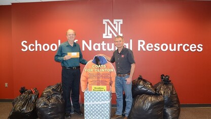 Ken Dewey (left) and SNR director John Carroll with the "Coats for Clinton" donations.