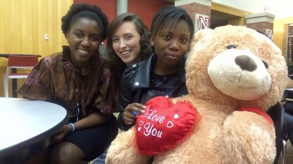 Grace Abraham (right) with a tedy bear given to her by classmates at Nebraska. 