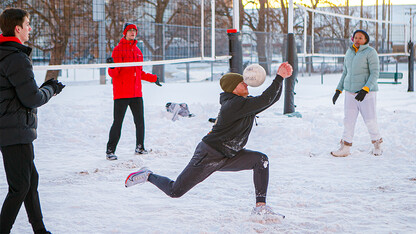 Students playing volleyball in snow