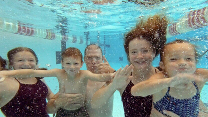 Kevin Van Den Wymelenberg and family underwater in pool