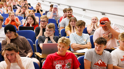 Students plug their ears in preparation for a chemistry demonstration on the first day of class