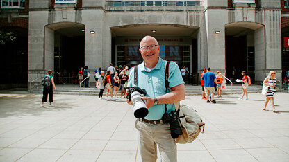 Chandler with his camera equipment, seen here photographing New Student Enrollment on city campus.