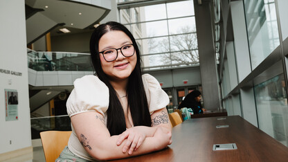 Photo by Murengezi Atali Benimana // Ann Vu — a marketing major from La Vista, Nebraska and a student worker in the College of Business — poses for a photo in Howard L. Hawks Hall. 