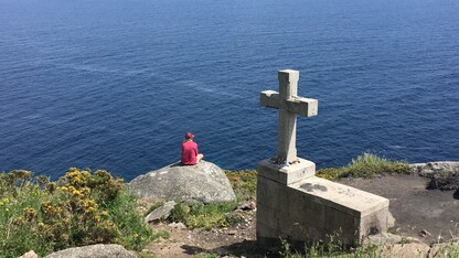 Nebraska's Tori Tyron looks out across the Atlantic Ocean at the end of the Camino de Santiago pilgrimage.