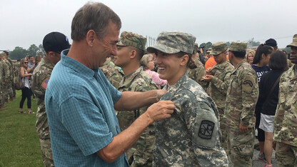 Molly Murphy smiles as her dad, Dan Murphy, pins on her jump wings after finishing Airborne training through an ROTC program. Murphy was one of the few Husker ROTC cadets in recent years to earn an invitation to attend the parachute training.