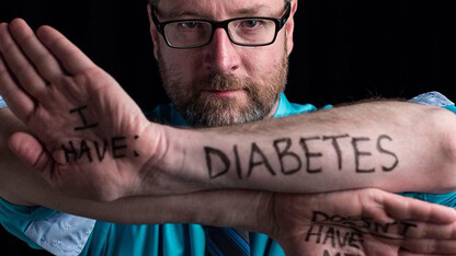 Mike Jackson, assistant director for marketing and communications with Student Involvement, poses for the Dear World project during a conference in New Orleans. The project, which allows people to tell their story through a few words and a photo, will make a stop at UNL on April 7.