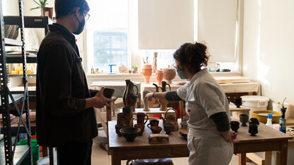 A visitor interacts with a graduate student at last year’s Open Studios event. This year’s Open Studios event is Nov. 11. Photo by Eddy Aldana.