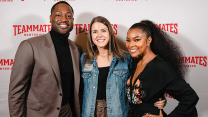 Nebraska alumna Janey Malcolm (center) stands with Dwyane Wade (left) and Gabrielle Union during a September Teammates event in Omaha.