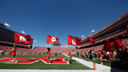 Spirit squad members charge onto the field during Sept. 10's Nebraska-Wyoming game. 