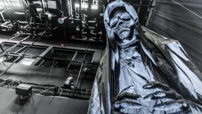 Large blue skeleton figure looming in haunted house