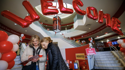 Misty and Kaegan Fredrickson of Britton, South Dakota, look over the Admitted Student Day program in the Nebraska Union on March 23.