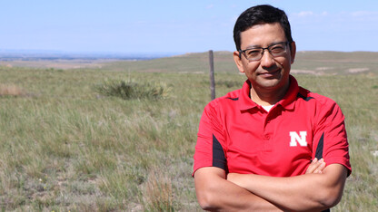 Bijesh Maharjan stands in front of a pasture north of Scottsbluff consisting of native soil and plant communities. His concept would define Soil Health Gap as the difference between soil health in an undisturbed native virgin soil and soil health in a giv