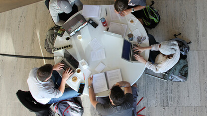 Students study at a table in Sheldon's Great Hall.