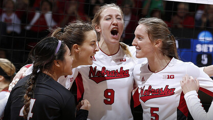 Husker volleyball players celebrate during a match. UNL faculty and staff have until June 12 to submit applications to purchase season tickets for the Cornhusker volleyball team's 2015 season.