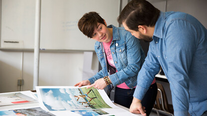 Walker Pickering, an assistant professor of art, discusses a photography project with a UCARE student.