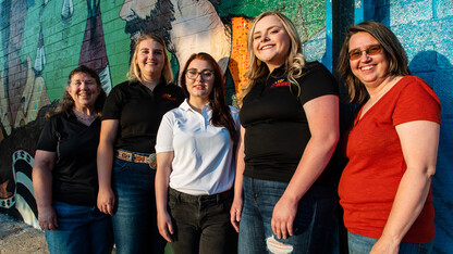The three Rural Fellows and local partners pause in front of one of the downtown Chadron murals. Jenny Nixon (left), Chantelle Schulz, Hanna Jemison, Jacy Hafer and Kerri Rempp, tourism director for the Discover Northwest Nebraska.