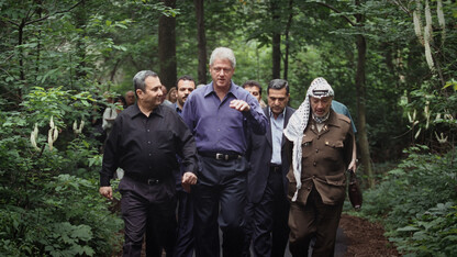 Leaders (front, from left) Ehud Barak, Bill Clinton and Yasser Arafat walk during Israeli-Palestinian peace talks at Camp David in July of 2000. The failed talks — and negotiations that led up to them — are featured in "The Human Factor," which opens June 11 at the Ross.