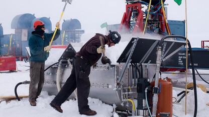 UNL drillers Daren Blythe and Dar Gibson shovel snow into a melter that provides water for the hot water drill that melted a hole through 800 meters of ice on top of subglacial Lake Whillans.