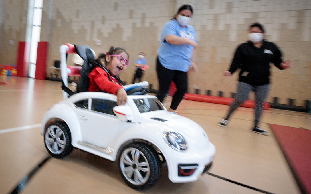 Four-year-old Dayana Torres enjoys the new, battery-powered car that UNL and UNMC students modified for her. Bowles was part of the team that modified the car for Torres.