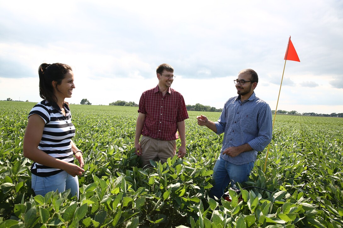 University of Nebraska–Lincoln student researchers Bella Possignolo (left) and Sandeep Bhatti (right) conduct fieldwork with DWFI Faculty Fellow and Nebraska irrigation engineer Derek Heeren. 