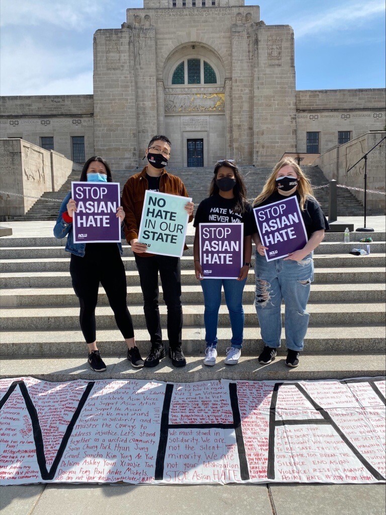 Tamayo Zhou stands with his co-organizers at the rally near the Nebraska State Capitol.