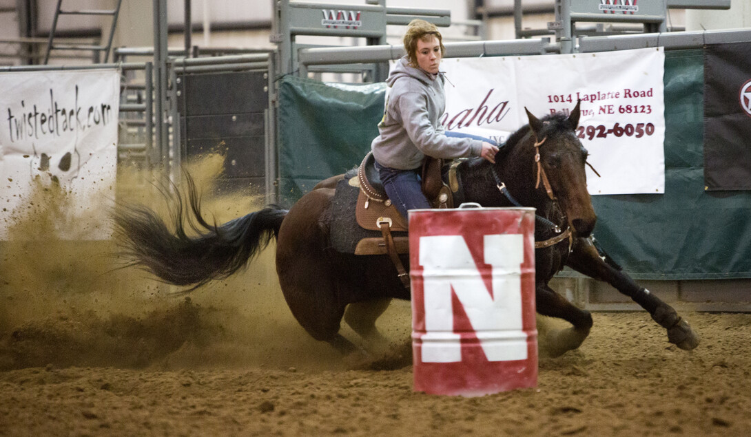 Sam Asmus, a sophomore agribusiness major, and her horse concentrate as they round the first of three barrels during a practice run.