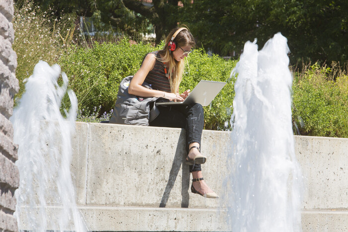 A UNL student stays cool near Broyhill Fountain on Monday. Temperatures this week are expected to be very hot -- mid- to upper 90s through at least Saturday.