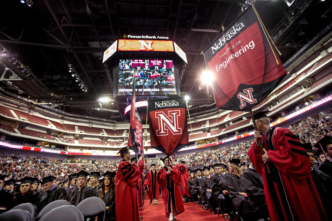 The procession of gonfalons winds its way onto the Pinnacle Bank Arena floor.