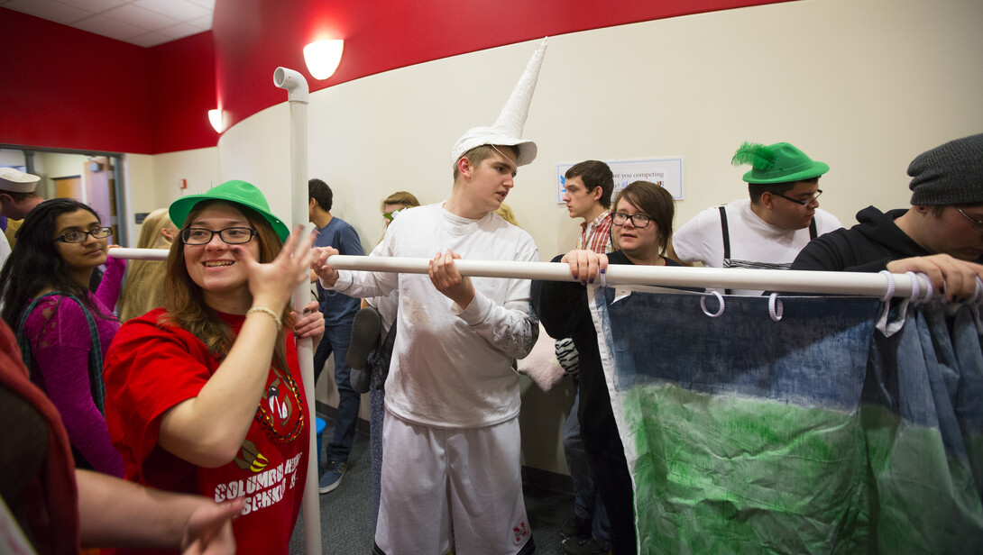 It was schwere Kyrperverletzung (mayhem) in the Nebraska Union as 1,300 high schoolers filled the union for the 38th Annual Modern Language Fair. Dalten Heithoff of the Columbus High School German drama team helps assemble a backdrop before their presentation.