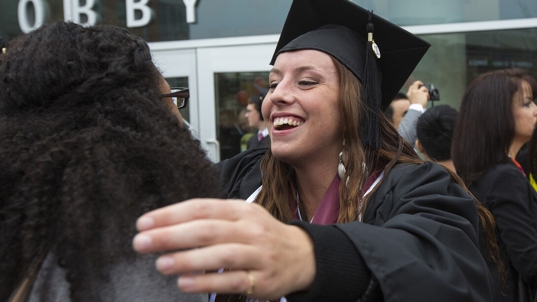 Taylor Wagner gets a hug following UNL's Dec. 20 commencement exercises.