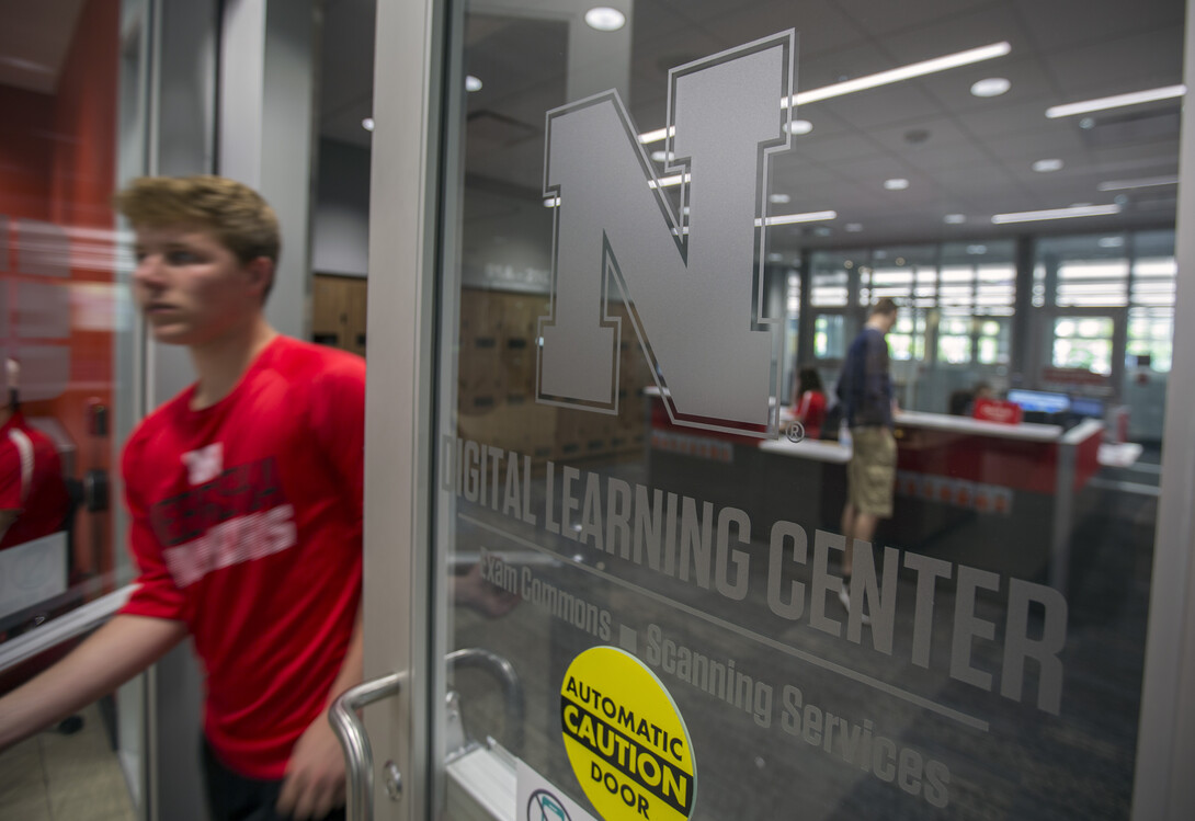 A student passes through the door to the Digital Learning Center after completing a final exam on May 4.