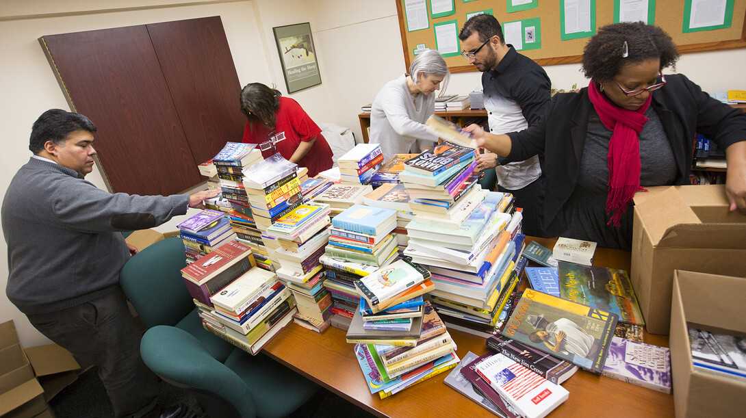 Members of UNL's Institute for Ethnic Studies box up donated books prior to sending them to the Ferguson Municipal Public Library. More than 600 books were collected for campuswide effort.