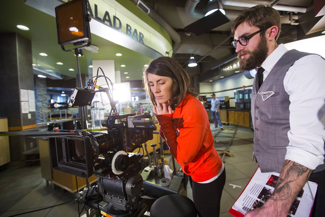 Nebraska's Amanda Christi and Andrew Swenson film a recruitment video in the Abel-Sandoz Dining Center. The admissions duo also led Nebraska's production of the "In Our Grit, Our Glory" institutional spot.