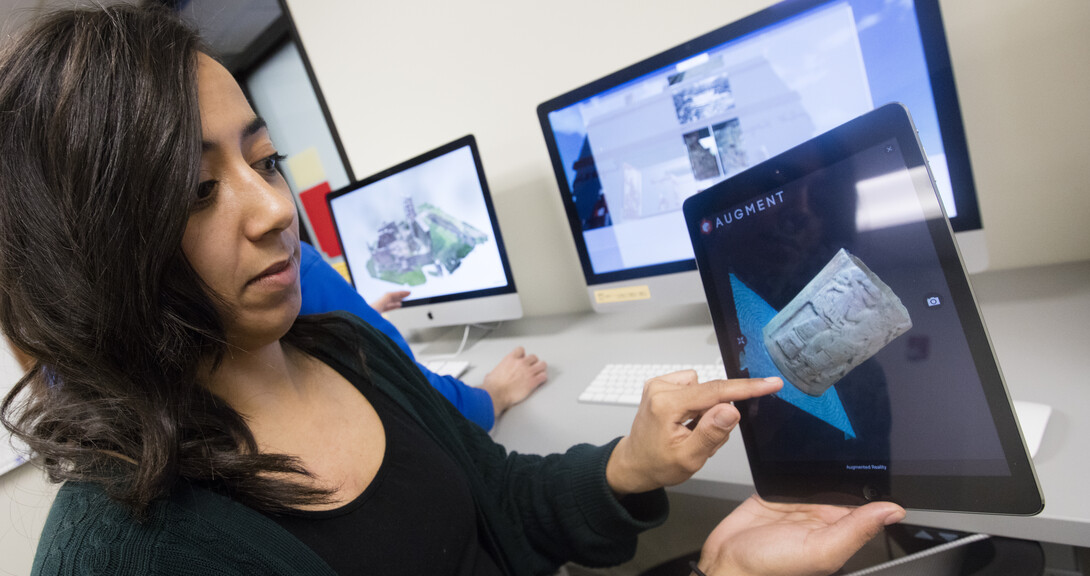 Stephanie Sterling, a December 2015 graduate in Anthropology, demonstrates 3-D software to view a carved column. 