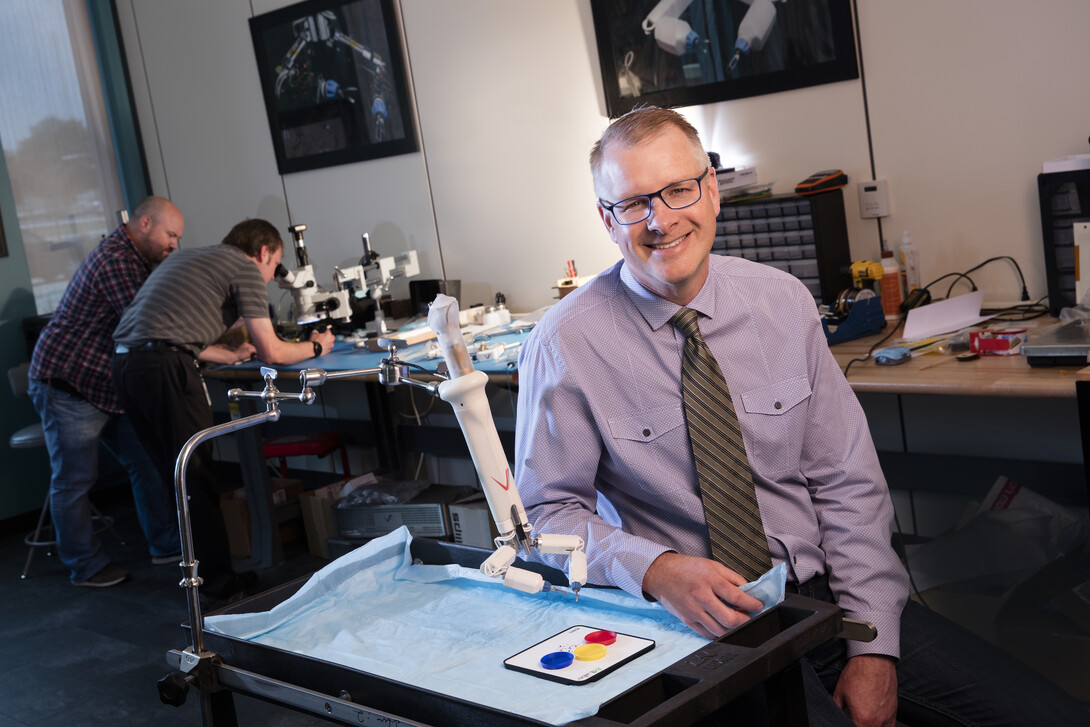 Shane Farritor has been named a Fellow of the National Academy of Inventors. He is pictured here with a prototype of one of his advanced miniaturized robots that shows promise for colon resection, a procedure used to treat diverticulitis, large colon polyps, precancerous and cancerous lesions of the colon and inflammatory bowel disease.