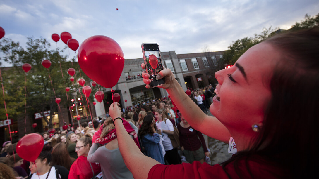 Kylie Gunderson photographs her balloon before the release during the 2016 homecoming pep rally.