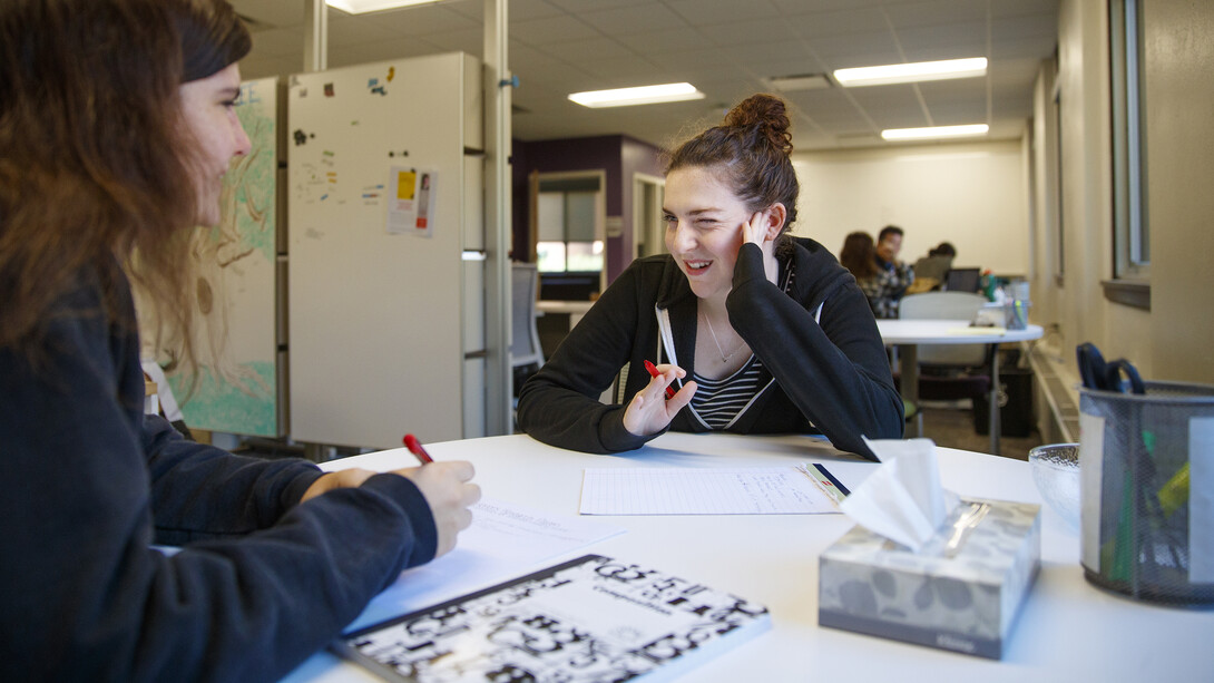 Writing Center tutor Michaela Luckey (right) gives Cassie Kiihne opinions and options for a paper.