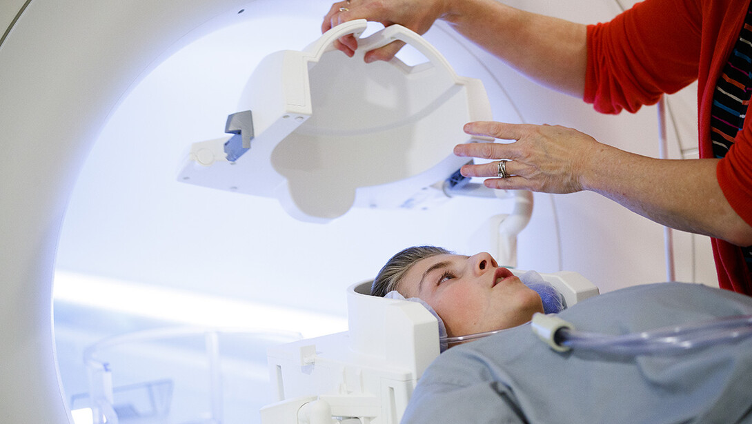 A boy gets placed in an MRI machine.