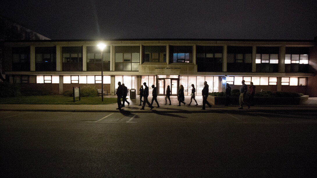 Participants in the annual campus safety walk pass in front of the University Health Center on April 27. Results of the survey are being included in a new initiative to integrate increased safety measures into outdoor environments on campus.