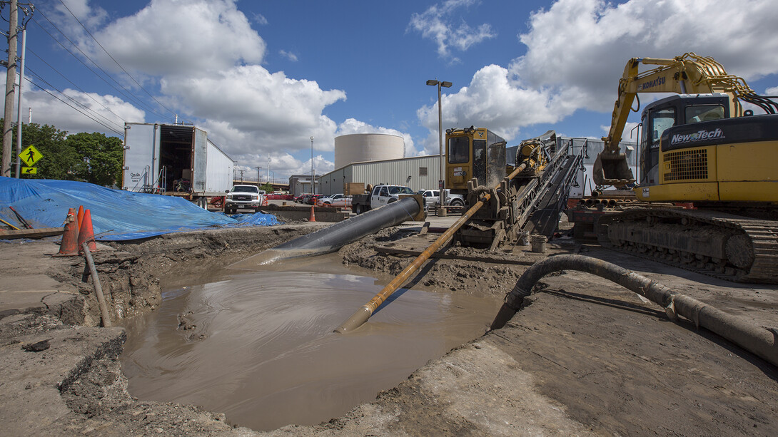 .Workers bore under the Antelope Valley creek bed to install a 36-inch-wide, 630-foot-long pipe that connects the thermal energy storage tank to the university's chilled water system.