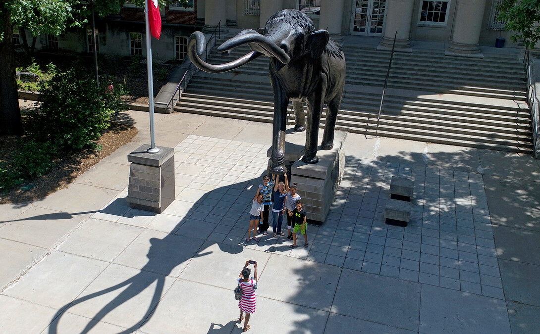 Visitors have their picture taken while touching Archie's foot for good luck. 