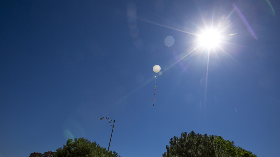 With experiments trailing on lines below, the high-altitude balloon takes to the sky during the June 24 test. The experiments were recovered in Cincinnati, Iowa.