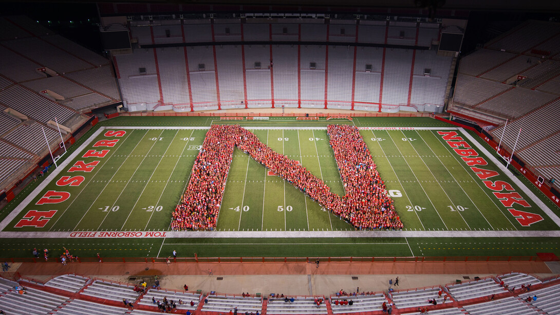 Members of Nebraska's 2017-18 freshman class pose for a class picture in Memorial Stadium after the tunnel walk on Aug. 18.